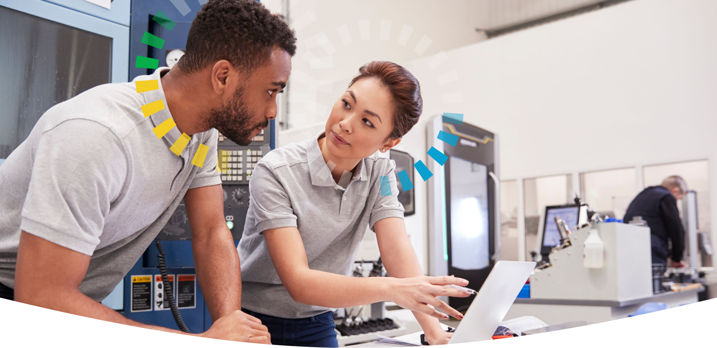 Man and woman coworkers in a manufacturing setting working around a laptop together. Both have DiSC style halos.